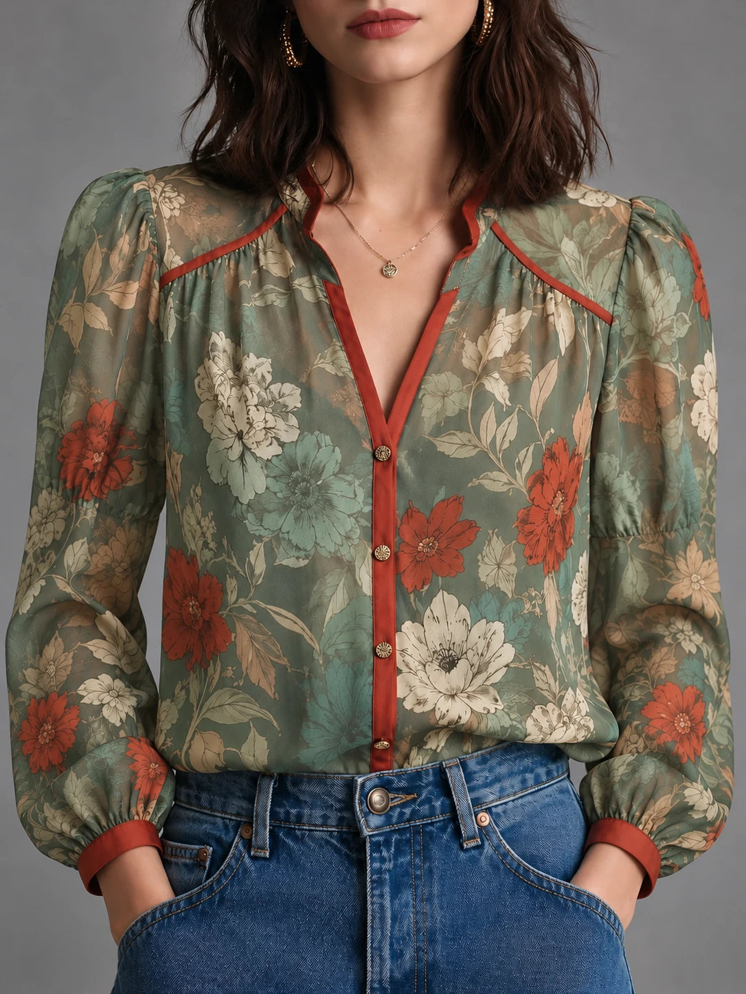 Sage green floral blouse with rust-red contrast trim, front view