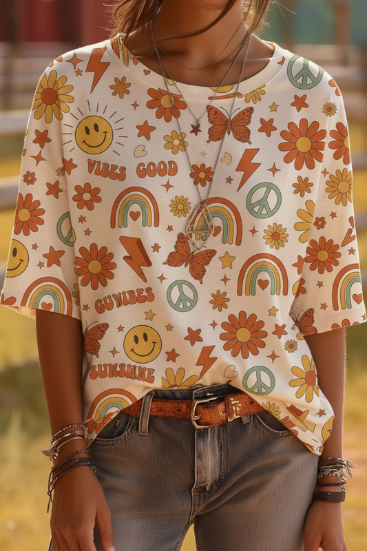 Retro boho print t-shirt with smiley faces, daisies, rainbows, and peace signs